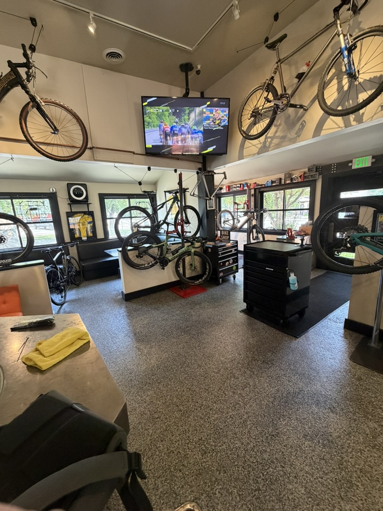 Power House bike service floor with bicycles and cycling on television