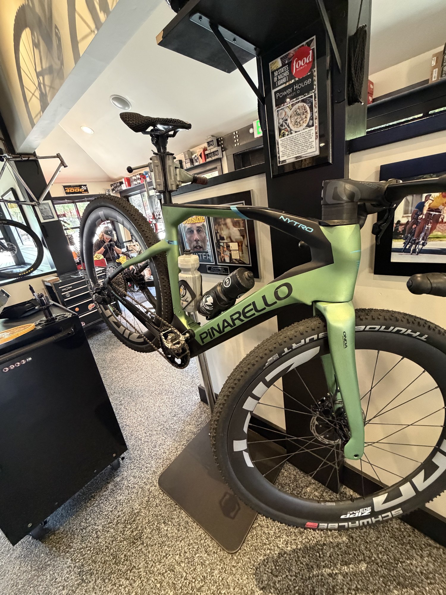 Green Pinarello e-gravel bike displayed inside Power House