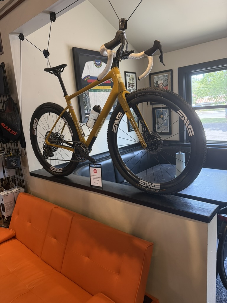 Gold performance bike with ENVE wheels on display