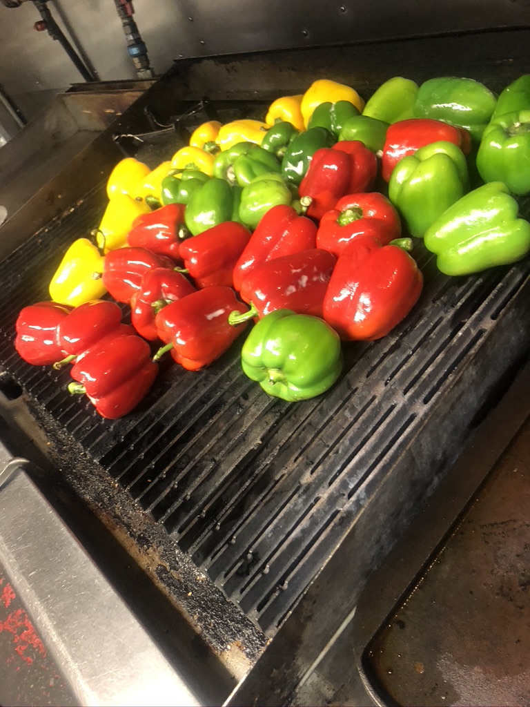 Red, yellow and green peppers roasting on the Power House grill