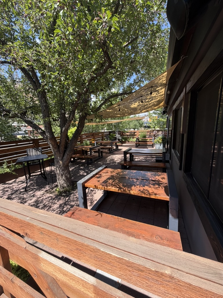Power House outdoor patio shaded by trees